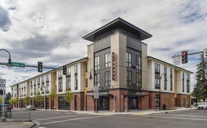 A mixed-used development sits at an intersection in Oregon. The first floor is a library. The other floors are affordable senior housing.