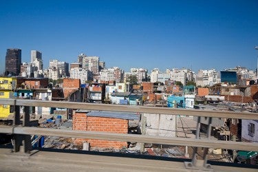 Informal dwellings in Buenos Aires Argentina Urban skyline with tall buildings in background with informal dwellings in foreground in Buenos Aires Argentina