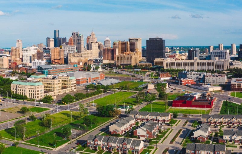 Image of downtown Detroit with a residential neighborhood in the foreground.