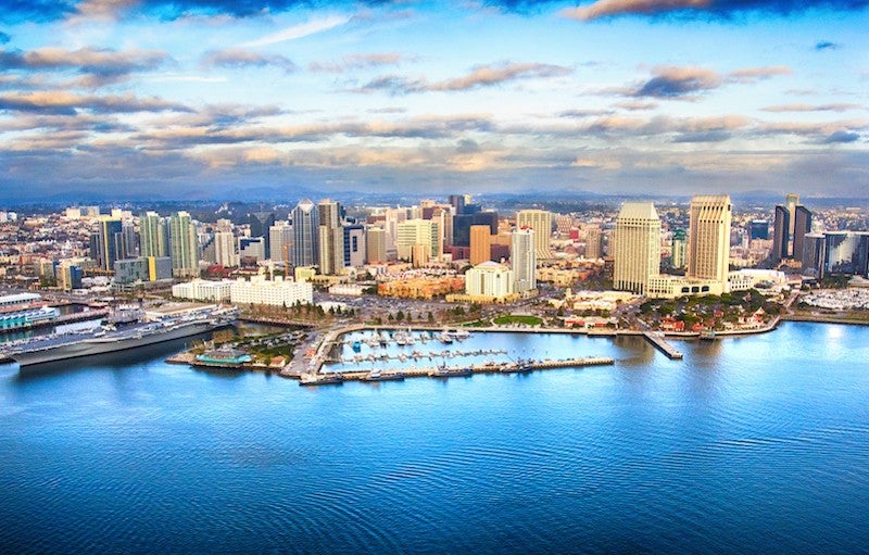 Water in the foreground, with tall buildings in the middle of the frame