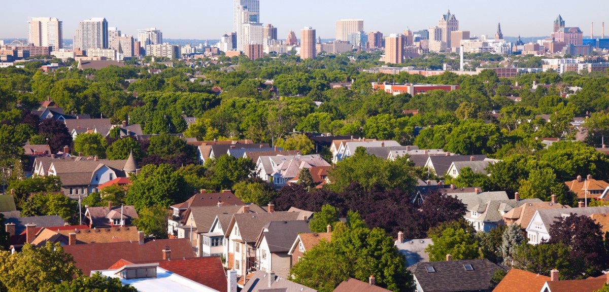 Milwaukee, Wisconsin An aerial photo of houses and trees with an urban skyline in the background